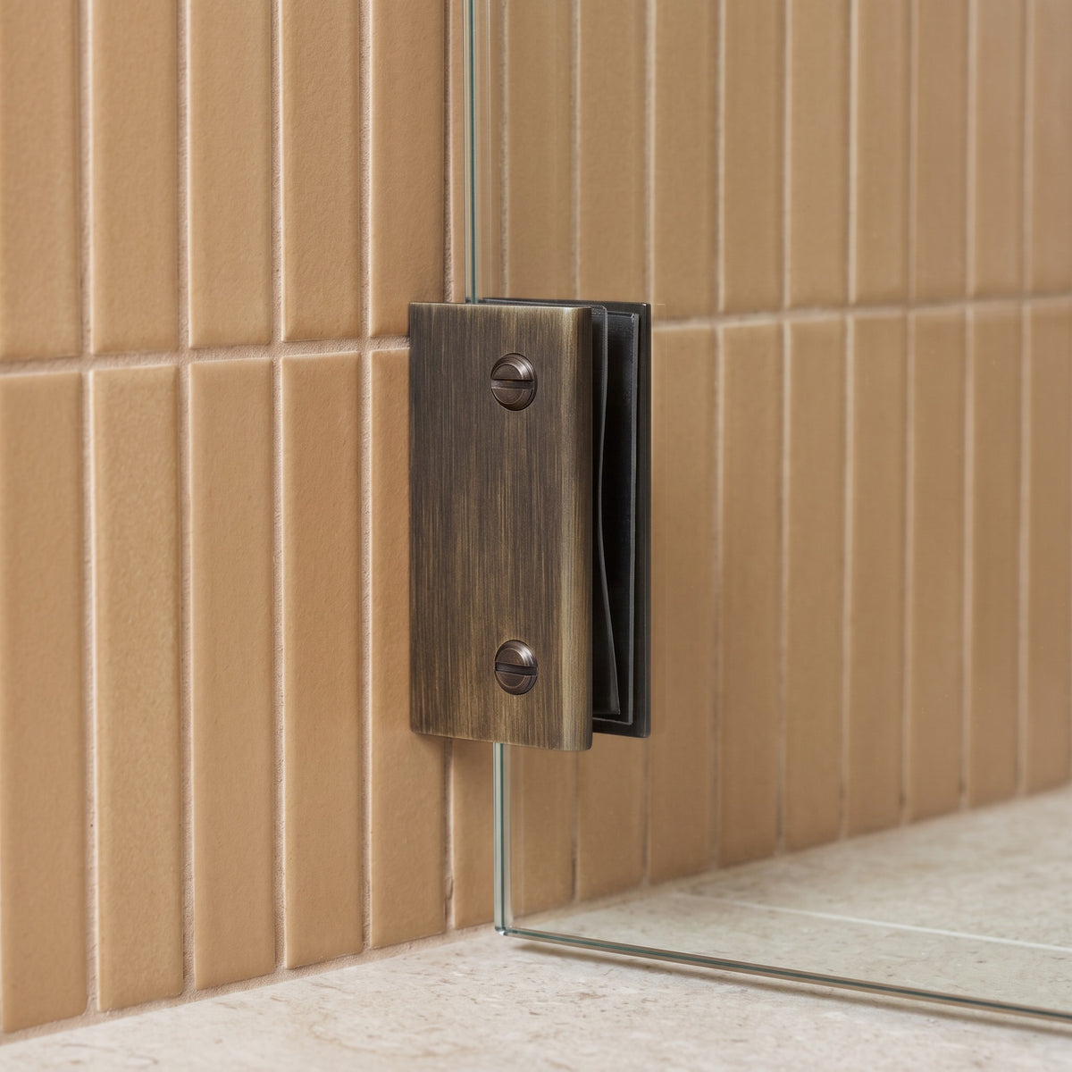Rhodes Shower Glass Clamp in Antique Brass on a glass shower screen