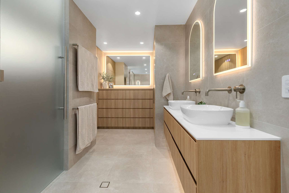 Florence LED smart mirror above a timber vanity in a warmly lit narrow bathroom