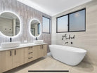 Dual oval Smart LED mirrors in couple's split-design bathroom with cabinet and freestanding bathtub