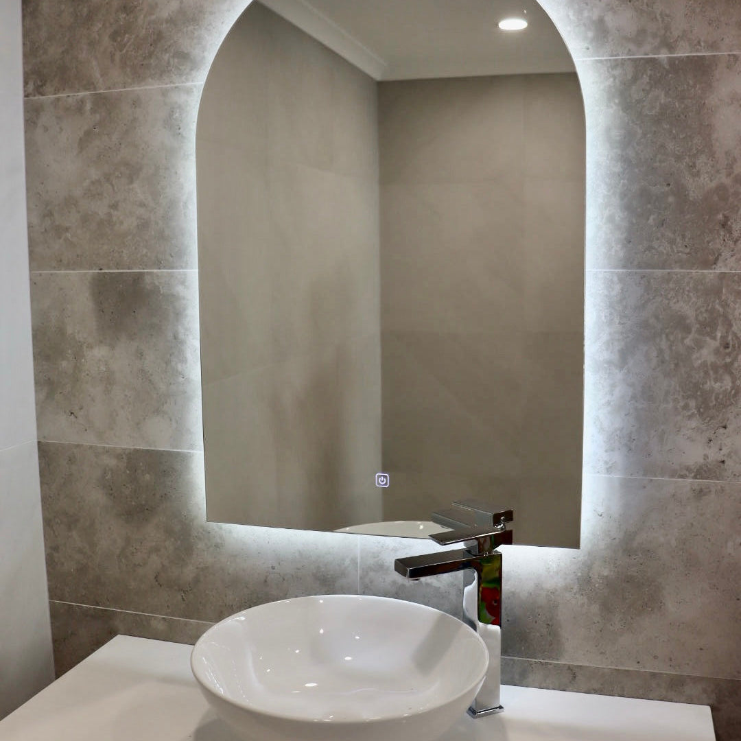 Illuminated Arch-Shaped LED Mirror on Greyish Brown Wall with White Sink and Cabinet
