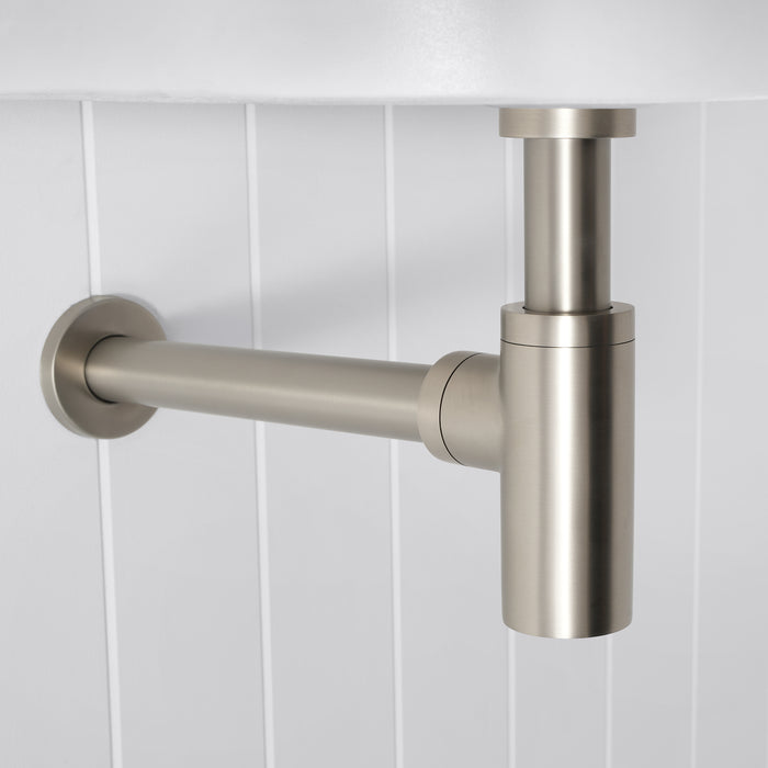 Firenze Basin Bottle Trap in Brushed Nickel, side view of the wall pipe and round flange below a white basin