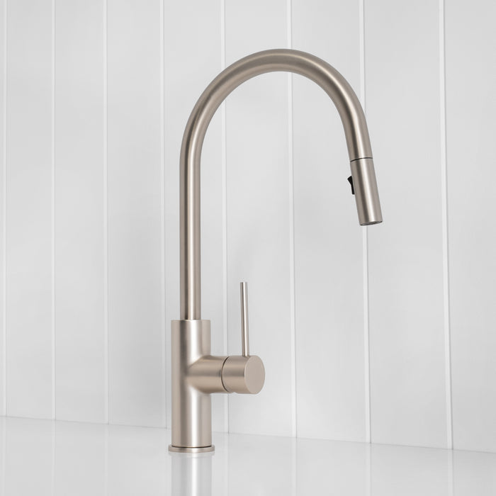 Porto Pull-Out Kitchen Mixer in Brushed Nickel, three-quarter view, spray head docked, on a white vertical-panelled wall