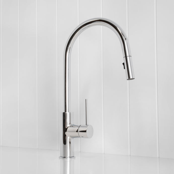 Porto Pull-Out Kitchen Mixer in Chrome, three-quarter view, spray head docked, on a white vertical-panelled wall
