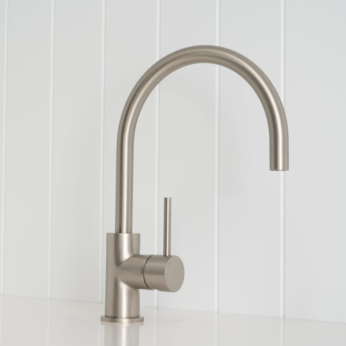 Como Kitchen Mixer Tap in Brushed Nickel, three-quarter front view on a white vertical-panelled wall