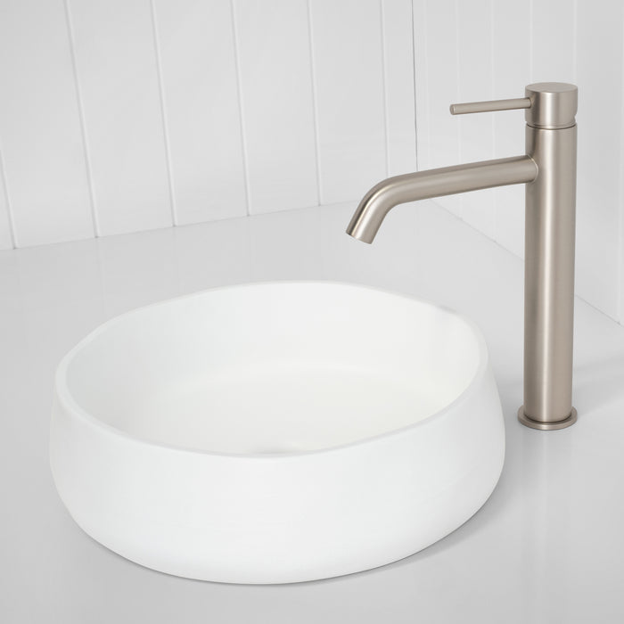 Vienna Tall Basin Mixer in Brushed Nickel, beside a round white vessel basin on a white vertical-panelled wall