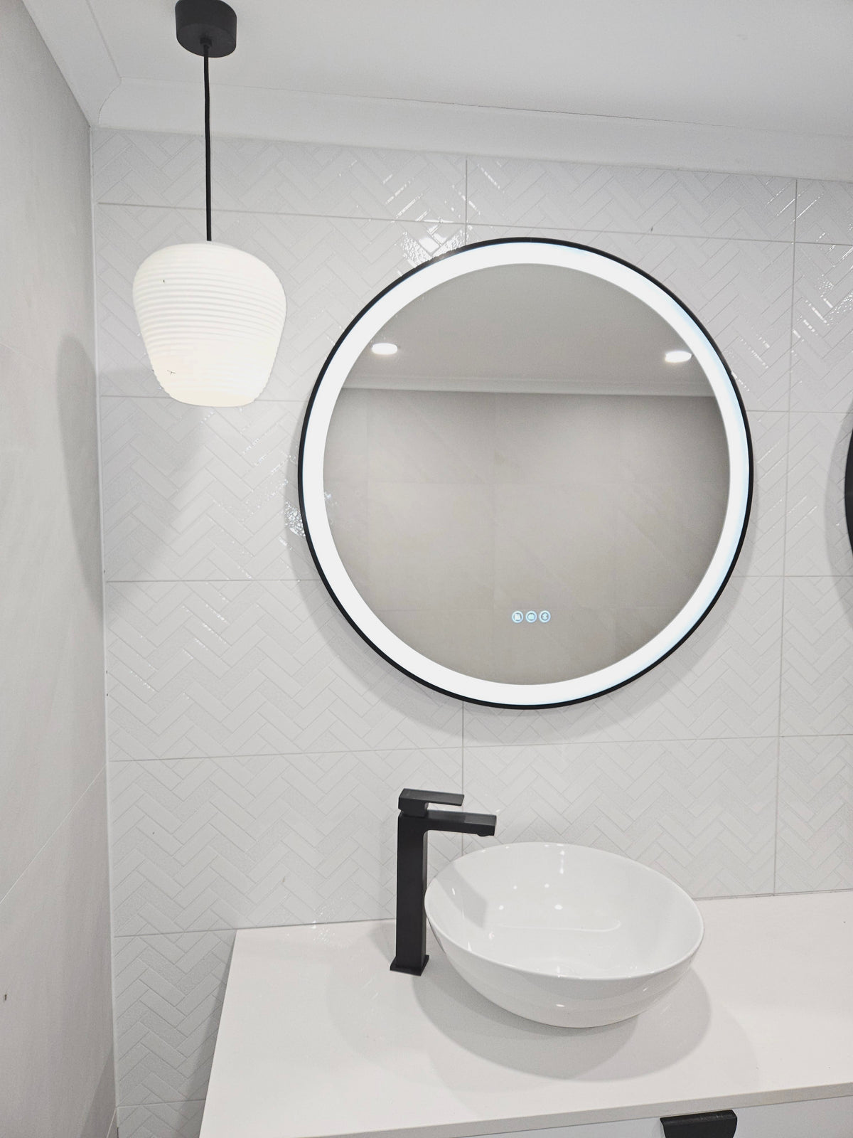Left-Side of White Powder Room with Black Accents, Smart LED Mirror, Pendant Light, and White Sink