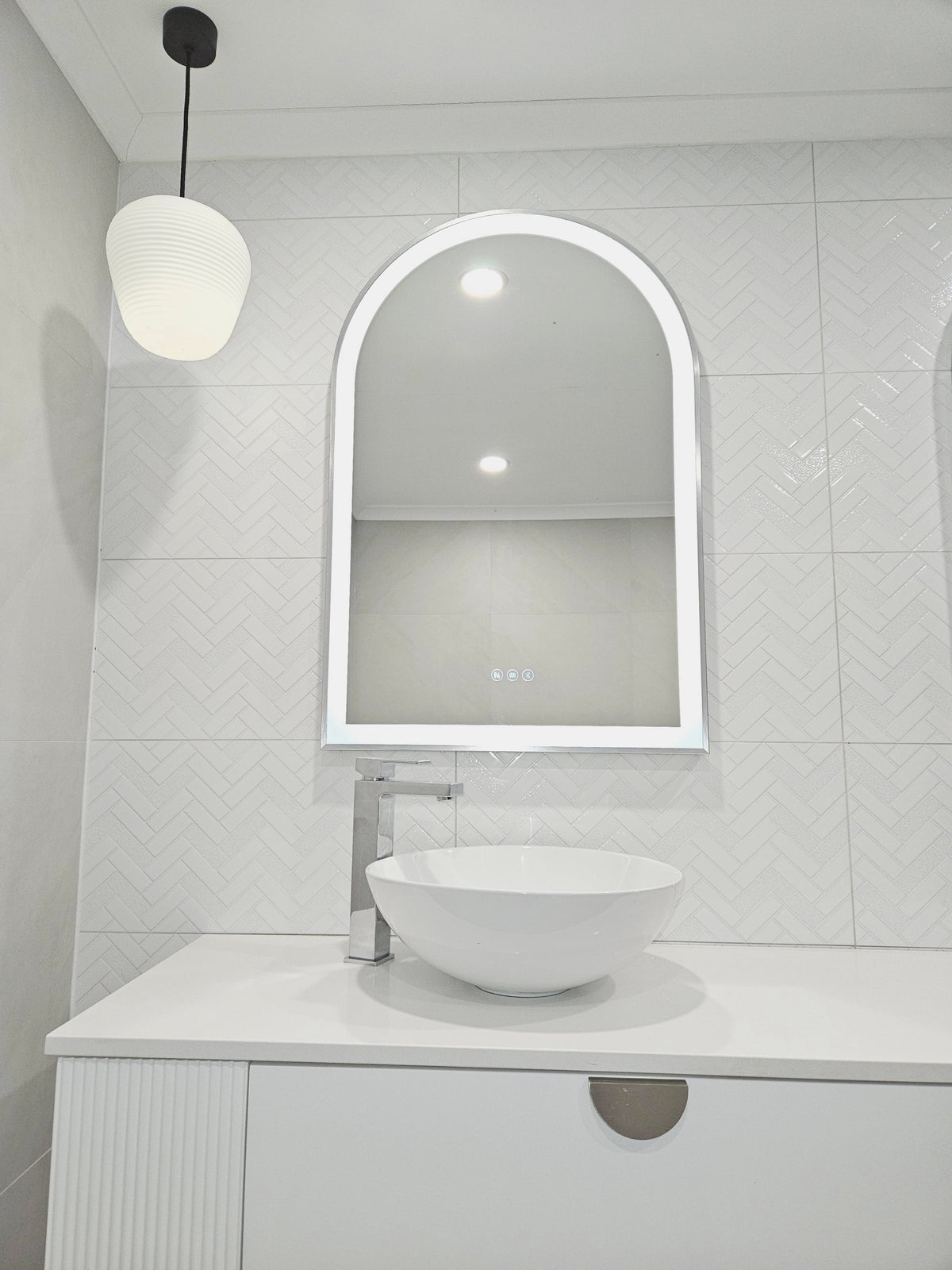 Powder Room with Arch-Shaped Smart LED Mirror, Pendant Light, White and Grey Wall, Vanity Cabinets
