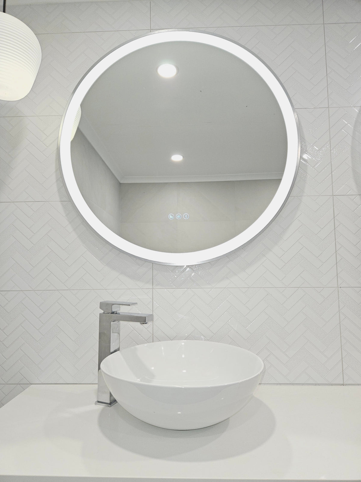 Low Angle Shot of Silver Frame Circle Smart LED Mirror in All-White Bathroom