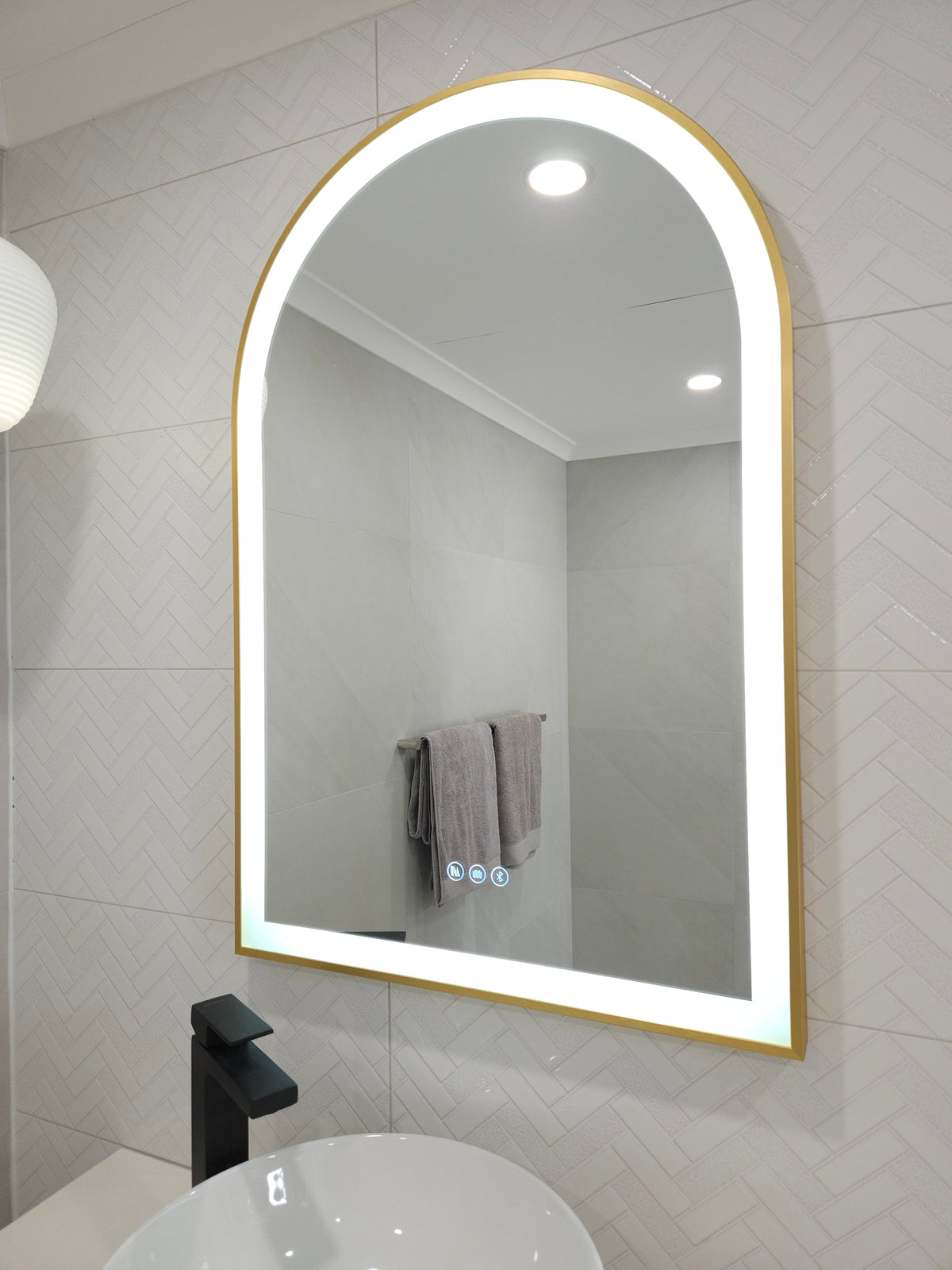  Stylish Gold-Framed Arch-Shaped LED Mirror illuminating White Bathroom