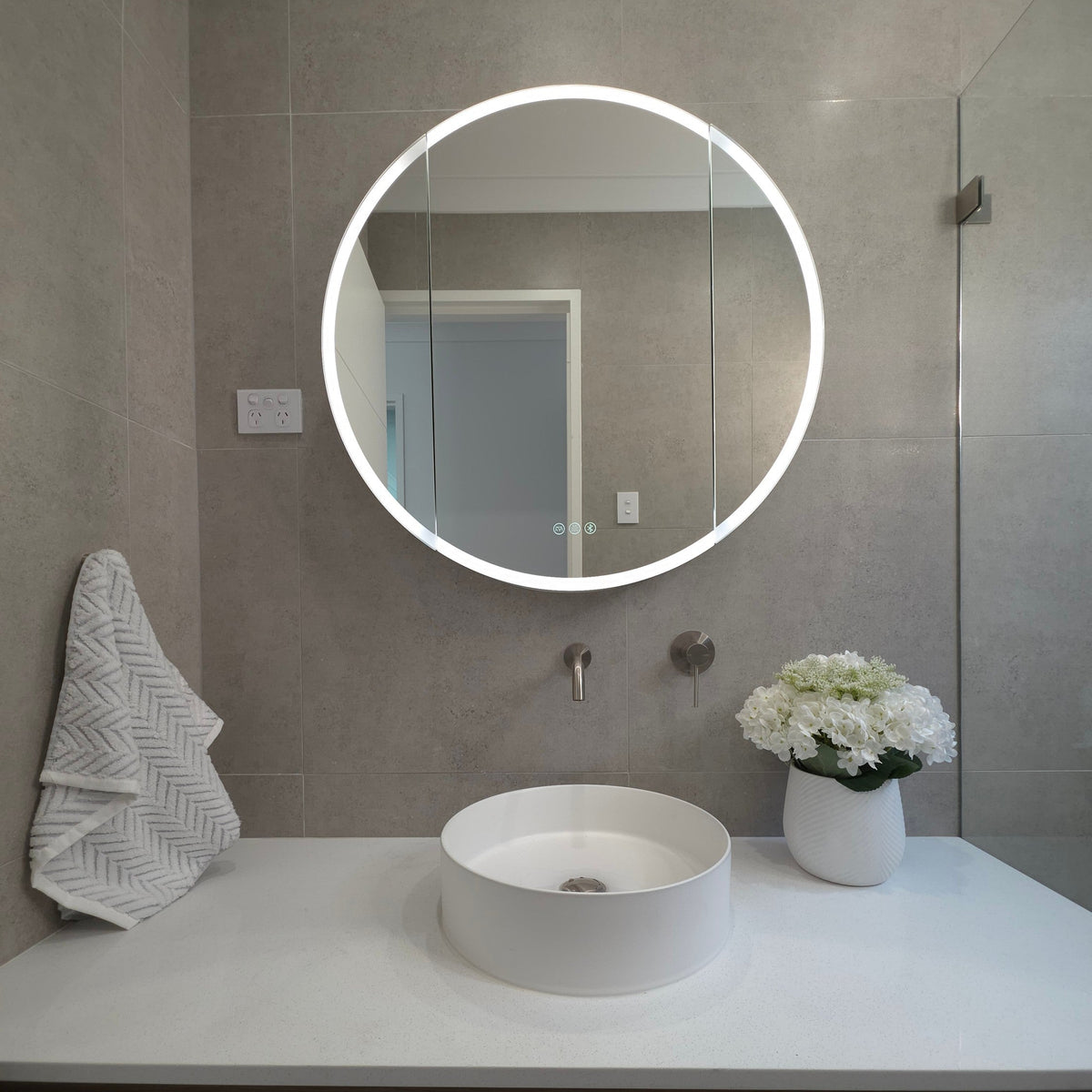 Outside view of round LED mirror cabinet with built-in demister