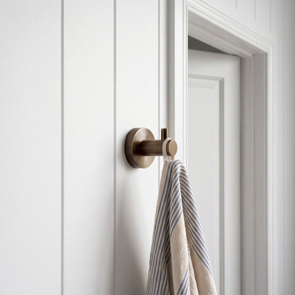 Copenhagen Robe Hook in Antique Brass in a bathroom