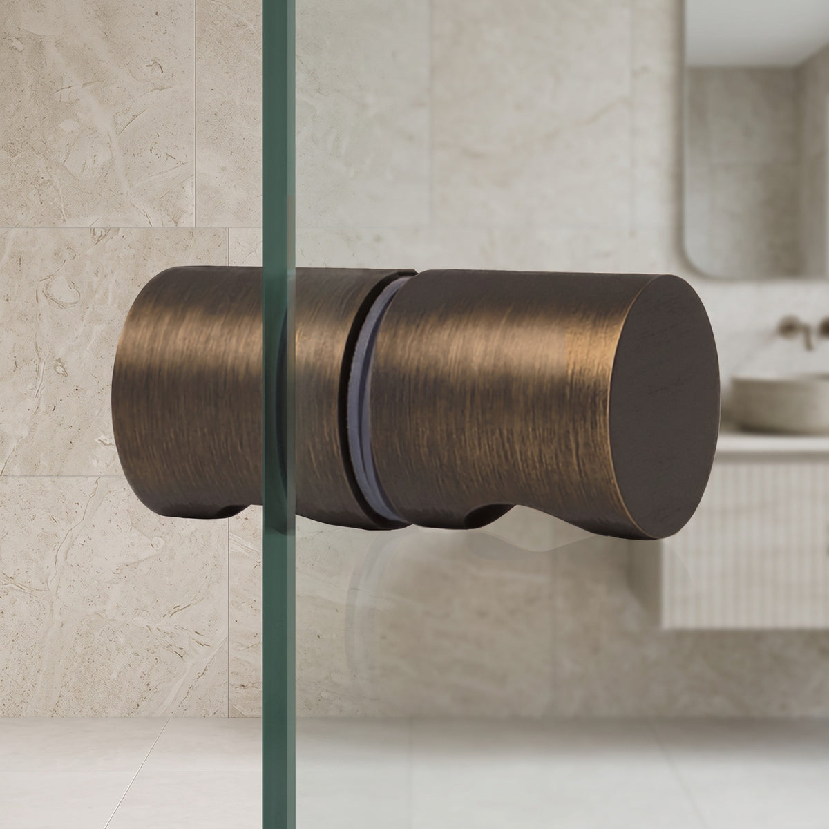 Corfu Shower Door Handle in Antique Brass on a glass shower door