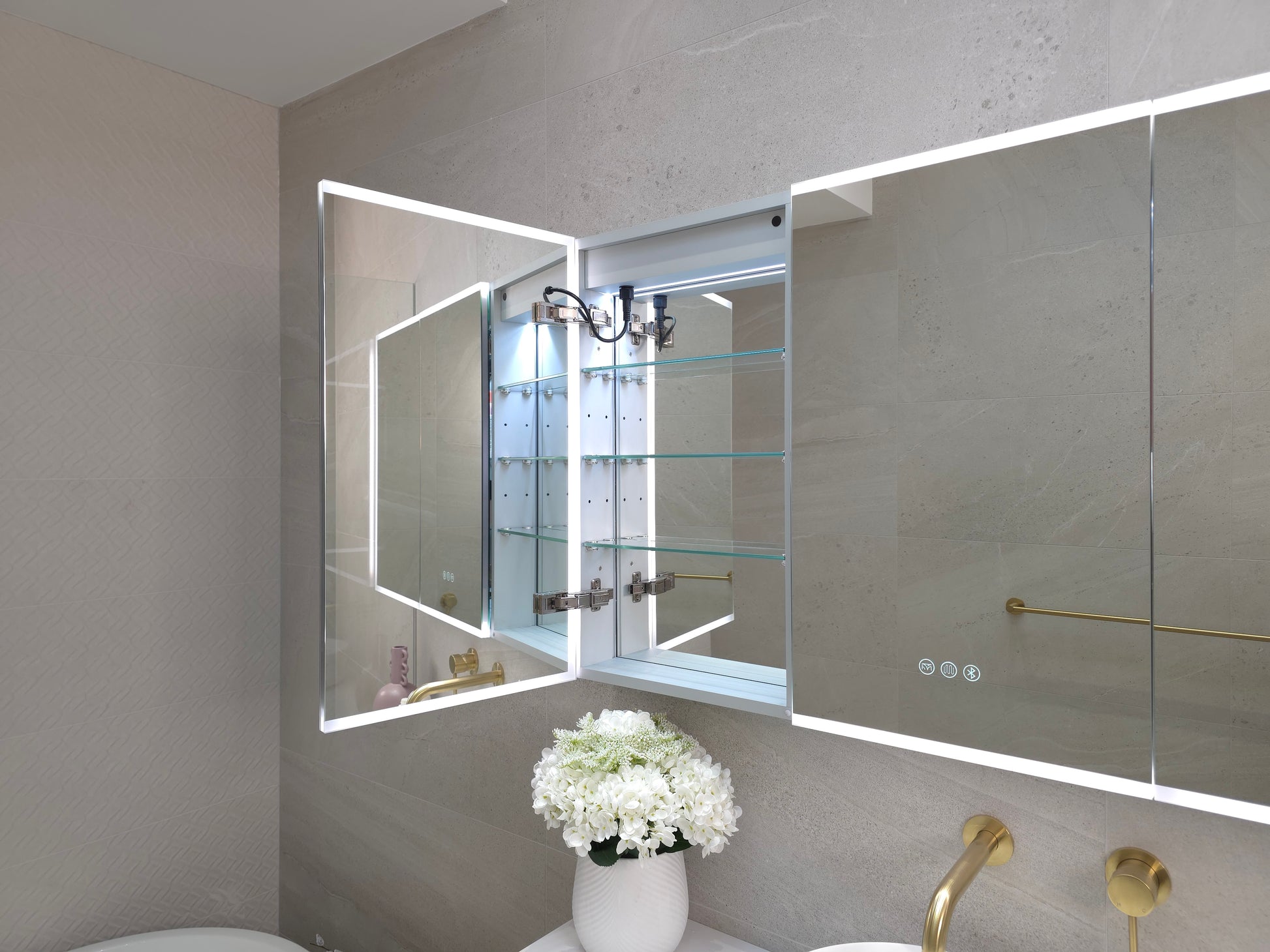 Inside view of frameless LED mirror cabinet with internal storage shelves by Invogue