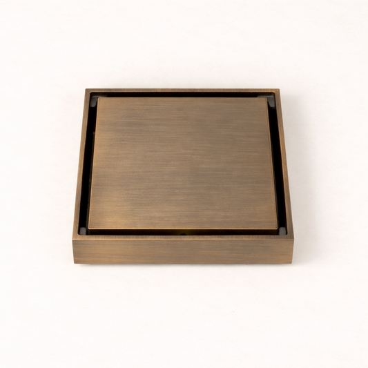 Granada Tile Insert Floor Waste in Antique Brass, three-quarter view of the cover on a plain white background