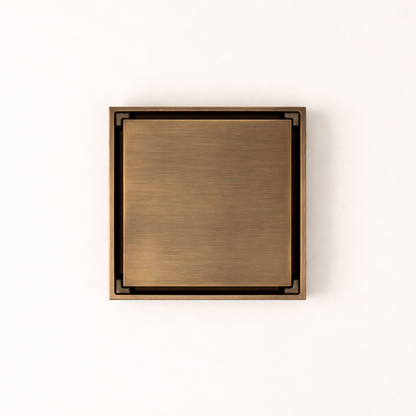 Granada Tile Insert Floor Waste in Antique Brass, top-down view of the square brushed cover on a plain white background