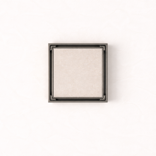 Granada Tile Insert Floor Waste in Brushed Gunmetal, top-down view, light stone tile in the cover on a plain white background