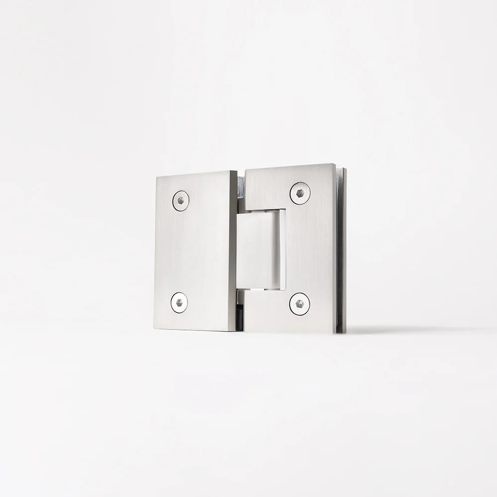 Geneva Shower Hinge Glass to Glass in Brushed Nickel, three-quarter view of the hinge standing on a plain white background