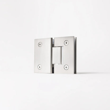 Geneva Shower Hinge Glass to Glass in Brushed Nickel, three-quarter view of the hinge standing on a plain white background