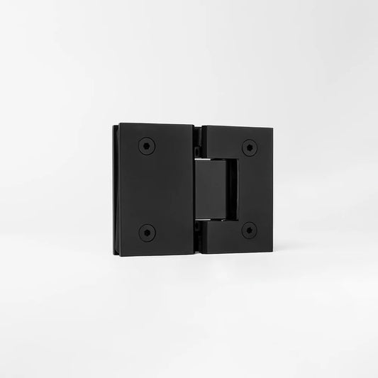 Geneva Shower Hinge Glass to Glass in Matte Black, three-quarter view of the hinge standing on a plain white background