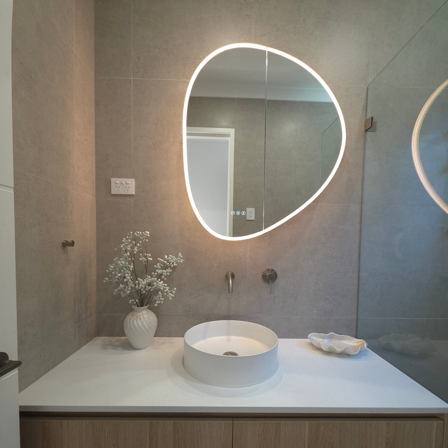 Frameless LED mirror cabinet organic shape with internal storage and lighting