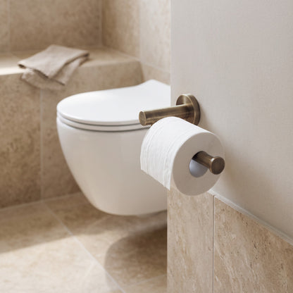 Lille Toilet Roll Holder in Antique Brass in a bathroom