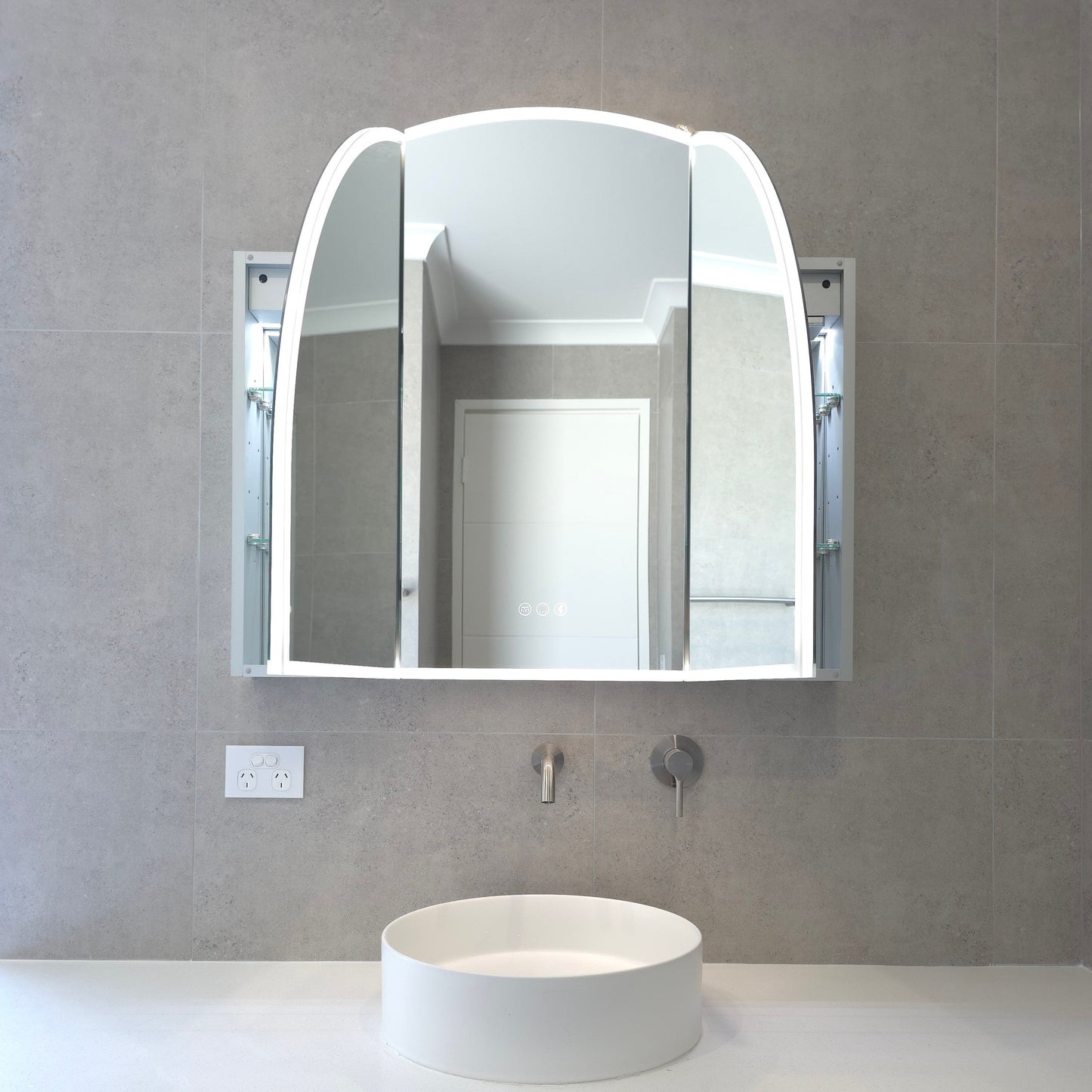 exterior view of arched frameless mirror cabinet with two doors open