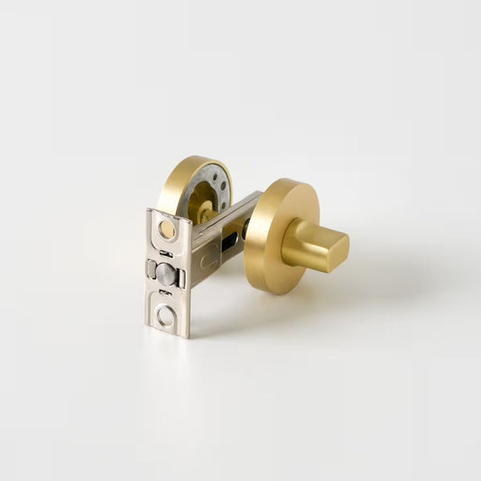 Prague Door Lock in Brushed Brass, lock mechanism with latch and both roses on a plain white background