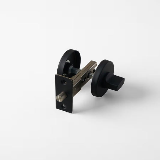 Prague Door Lock in Matte Black, lock mechanism with latch and both roses on a plain white background
