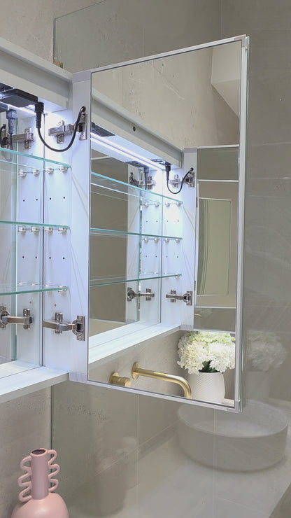 Frameless LED mirror cabinet showing internal storage and adjustable shelves