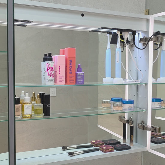 Video demonstration of frameless LED bathroom mirror cabinet showing internal ample storage with adjustable shelving