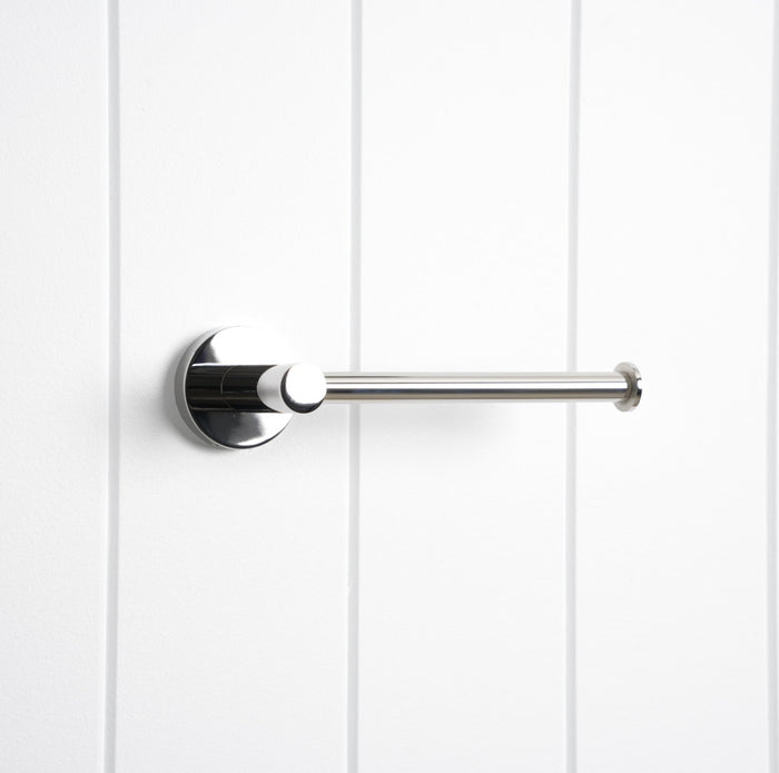 Lille Toilet Roll Holder in Chrome, three-quarter view, empty, on a white vertical-panelled wall