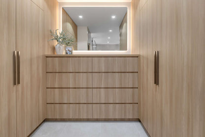 Florence LED mirror above a timber vanity flanked by full-height timber cabinetry