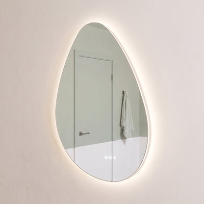 The Sorrento frameless backlit LED mirror hung portrait, angled view showing the slim glass edge floating off the wall