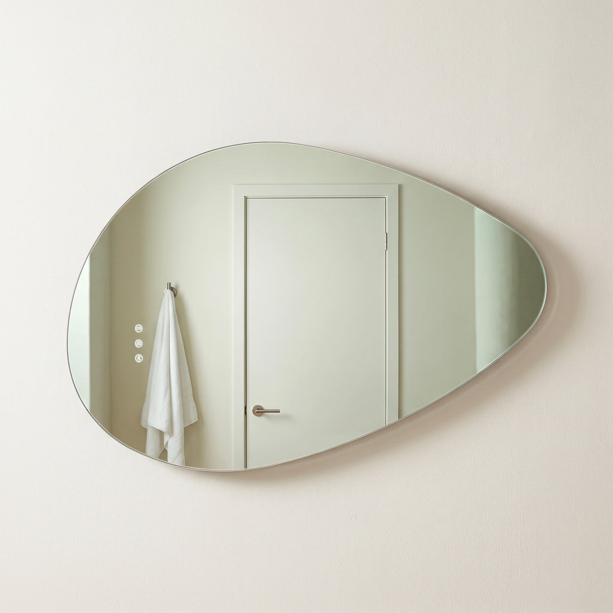 The Sorrento frameless backlit LED mirror, 800 x 550mm, backlight off, floating on a warm-white wall