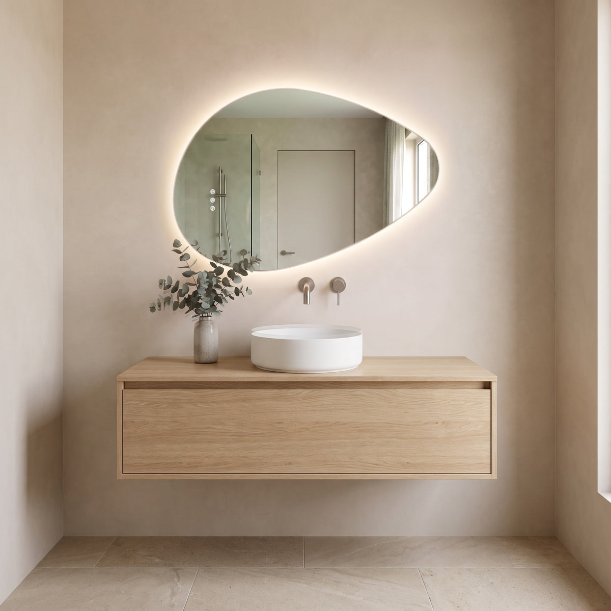 The Sorrento frameless backlit LED mirror, 800 x 550mm, above an oak vanity, white basin and brushed nickel wall tap
