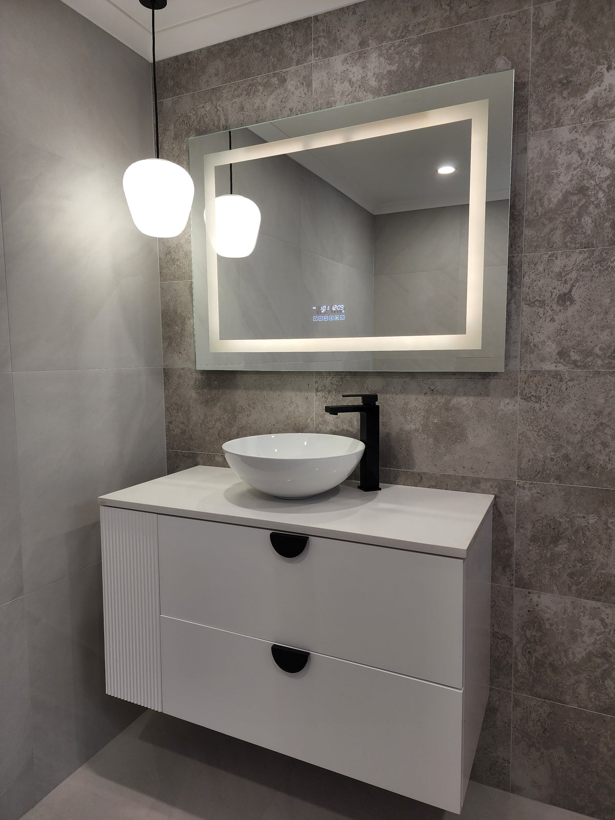 Vanity Area in Dirty Grey Bathroom with Front-Lighted LED Mirror, Pendant Light, and Cabinet