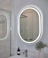 Lighted Pill-Shaped Silver Frame LED Mirror in White Bathroom