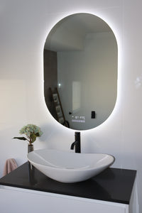 White Glossy Tiles and Sink in Modern Elegance Washroom with Pill-shaped Smart Mirror
